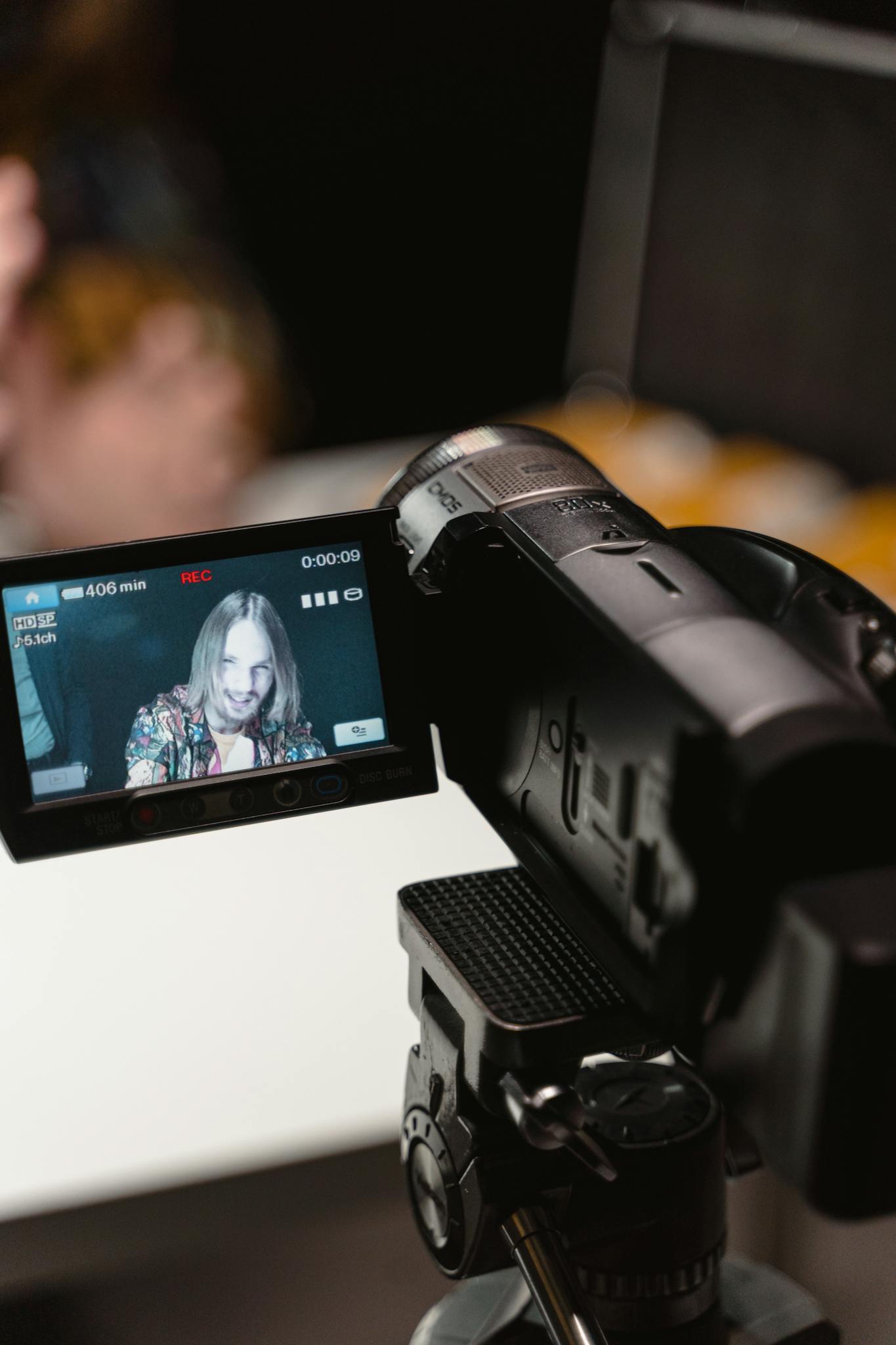 Close-up of a digital camera capturing footage indoors during a video recording session.